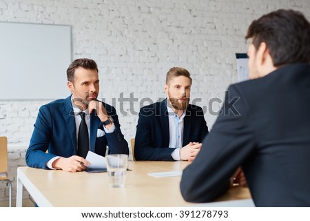 Job interview - two business man recruit candidate at their office