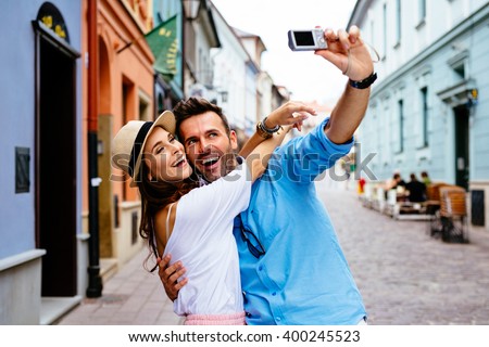 Happy couple taking selfie on the street during Europe vacation