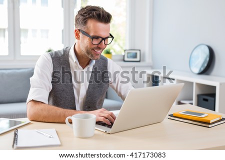 Young happy designer working on laptop from home - freelance concept