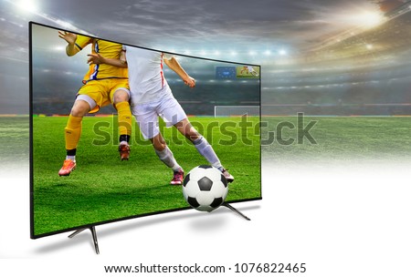 4k monitor watching smart tv translation of football game.liquid crystal monitor on the background of the stadium broadcasts the match in the evening time of the World Cup 2018.  Concept