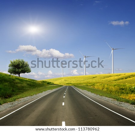 Rural road across the field to wind power