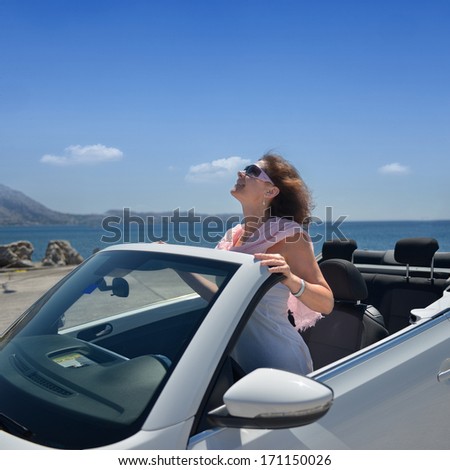 The lady at the resort on the beach in the car