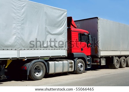 Red truck with cargo container in port