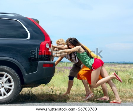 three girls push the broken car