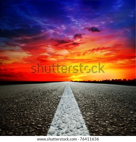 Asphalt country road at sunset