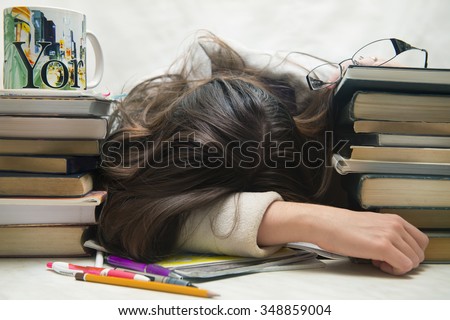 people, education, session, exams and school concept - tired student girl or young woman with books sleeping