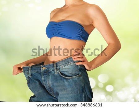 Young beautiful girl in jeans after losing weight