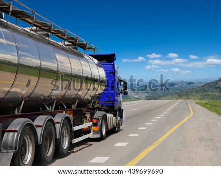 Tanker with chrome tanker on the highway. Working visit