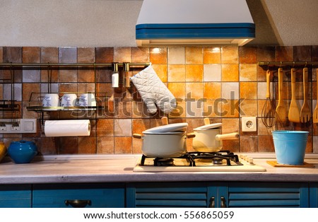 Interior blue kitchen. Preparing lunch at home on the kitchen stove