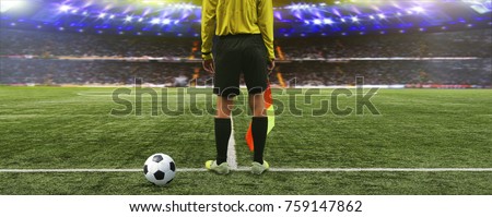 The referee soccer game stands on the field before the game, ready to blow the whistle