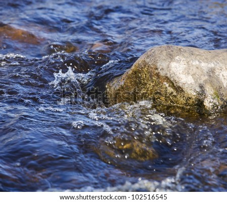 Moving water on a rock