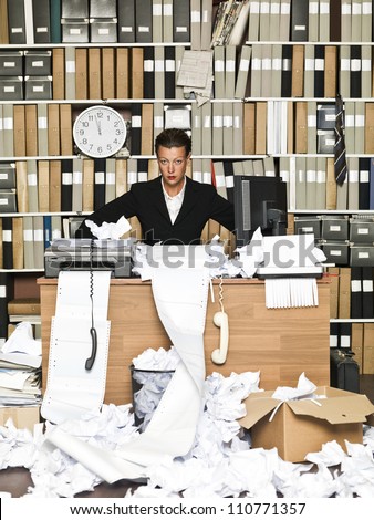 Frustrated Businesswoman at a messy office