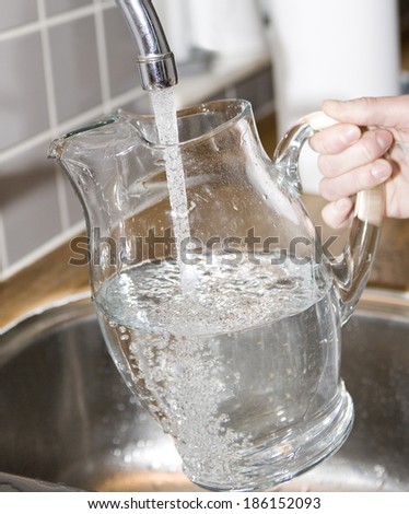 Filling water in a Glass Carafe