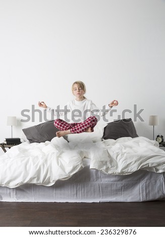 Meditating Girl Floating in the air of the bedroom