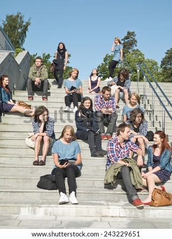 Large group of people sitting in the stairs