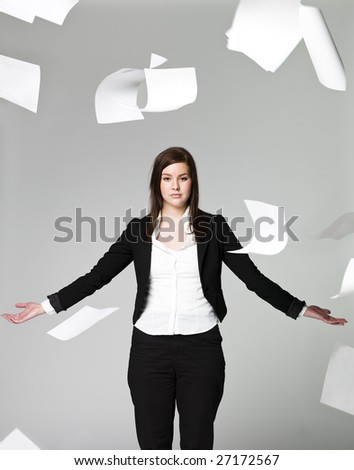 Office girl with a lots of papers flying around