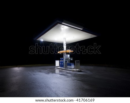 Petrol station at night with traffic in movement