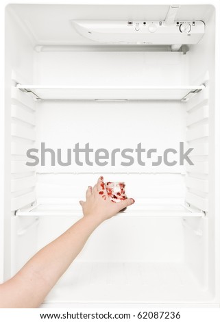 Hand reaching a can of jam in the fridge