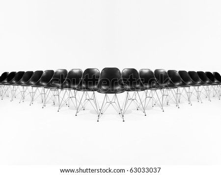 Formation of black chairs isolated on white background