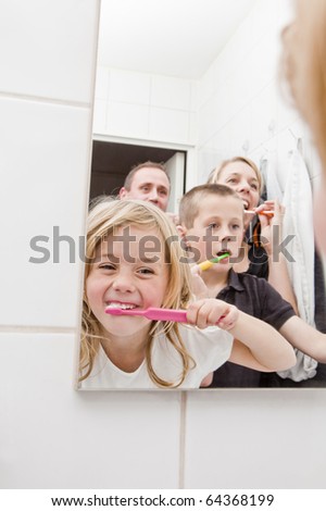 Family brushing teeths in the bathroom