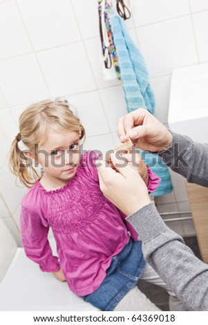 Father and Daughter Band-Aid in the Bathroom