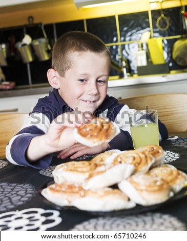 Young Boy reaching for sweets in the kitchen