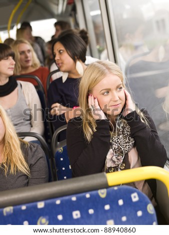 Woman listen to music while going by the bus