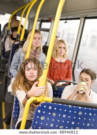 Woman pressing the stop button on the bus