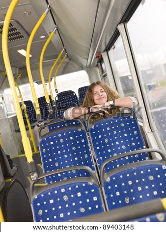 Young happy woman alone on the bus