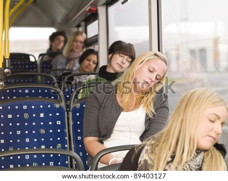 Small group of people sleeping on the bus