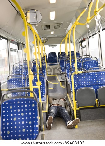 Young man lieing on the floor on the bus