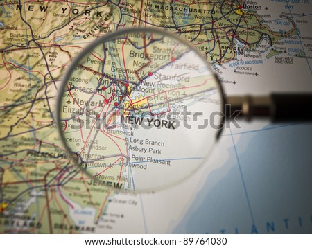 Magnifying Glass in front of a New York map