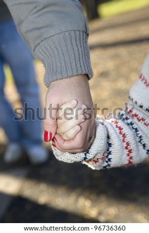 Mother and son holding hands