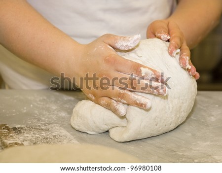 Close up of a woman kneading dough