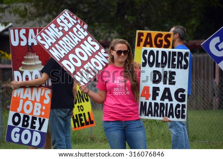 Members of the Westboro Baptist Church protest across the street from a Nuns on the Bus event in Topeka, Kansas on September 12, 2015. Westboro is also based in Topeka.