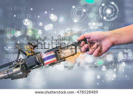 Industry 4.0, Robot and Automation concept. Handshake between a robot and a human on futuristic background.