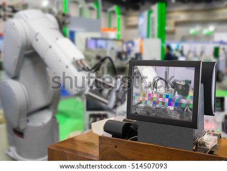 Industry 4.0 and Augmented reality for industry concept. Robotic and Automation system control application on computer screen on automate robot arm in smart manufacturing background.