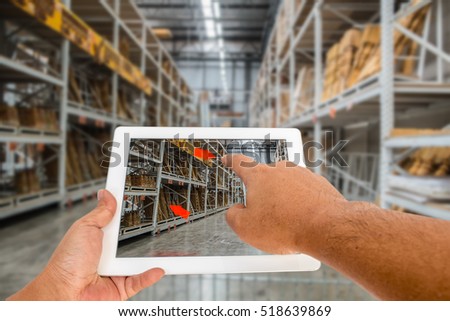 Augmented reality application for retail business concept. Hand holding digital tablet with A/R application on screen to finding interested product in construction depot.