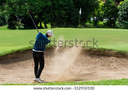 CHIANGRAI,THAILAND-AUG 22 : Thai young man golf player Pongsagorn Panyasu in action swing in sand pit during practise before golf tournament on August 22,2015 at golf course in Chiang rai,Thailand
