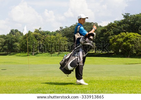 young man golf player in action to tell golf is good by show his thumb up during practice before enter golf tournament