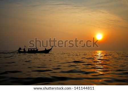 Sunset over the ocean with boat. Thailand.