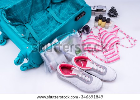 Packing of suitcase to go on vacation isolated on white background. Recommendations for packing suitcases.