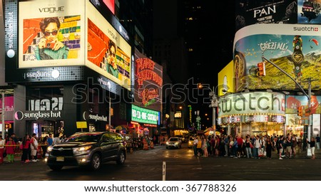 New York, USA - September 20, 2015: People and illuminated billboards at Times Square in Midtown Manhattan at night.