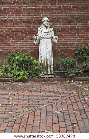 The weather-worn statue of a saint in a courtyard near the Old North Church in the North End of Boston, Massachusetts