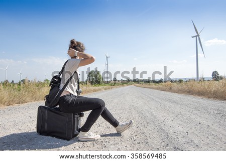 young girl traveling with bag waiting for bus