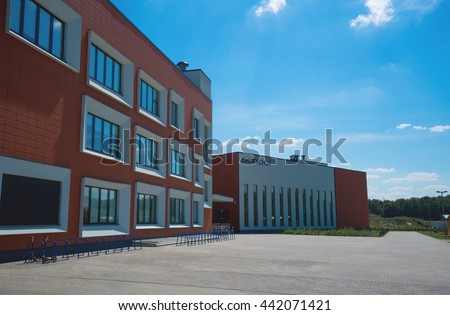 Modern school building. Empty school yard. Sunny day, blue sky.