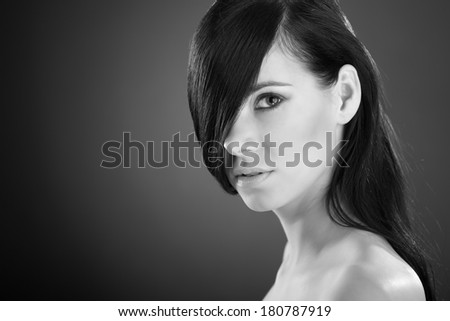 Woman with beauty long brown hair black and white - posing at studio