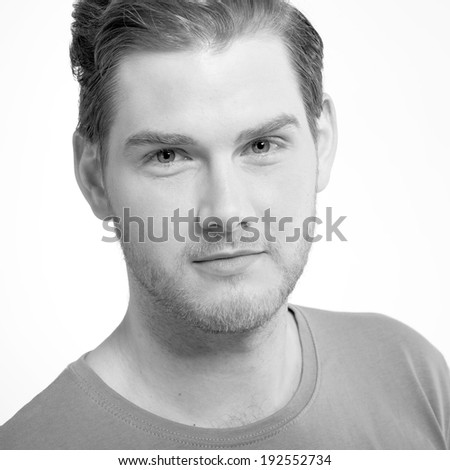 Black and white portrait of attractive young man on light background
