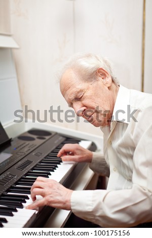 senior man with his eyes closed playing piano