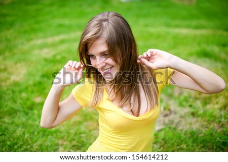 young woman stretching herself, enjoying fresh air and summer